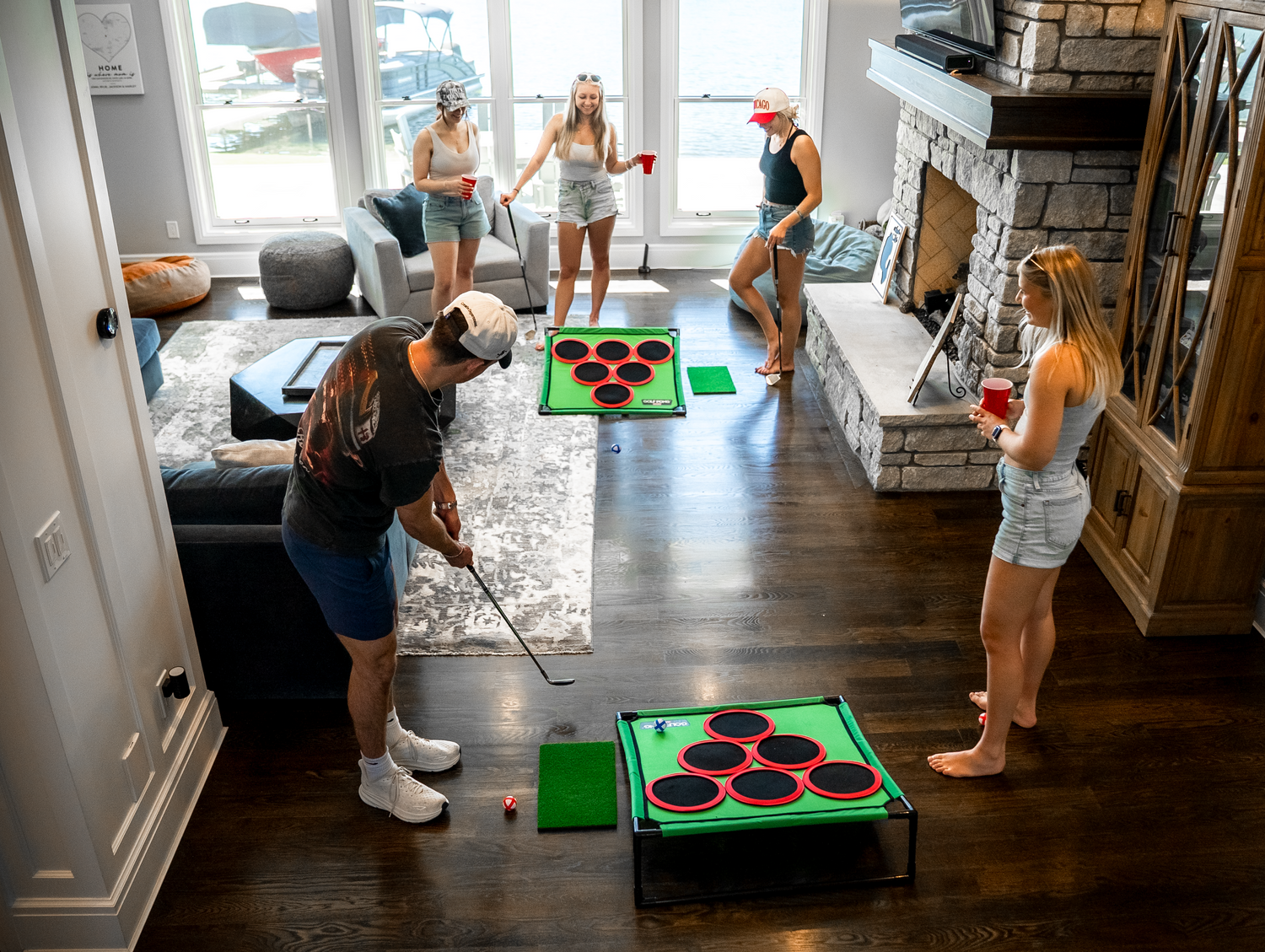 A group playing golf pong at a party while indoors