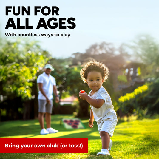 Toddler carrying a red foam ball across the lawn while playing the Golf Pong backyard golf game with dad