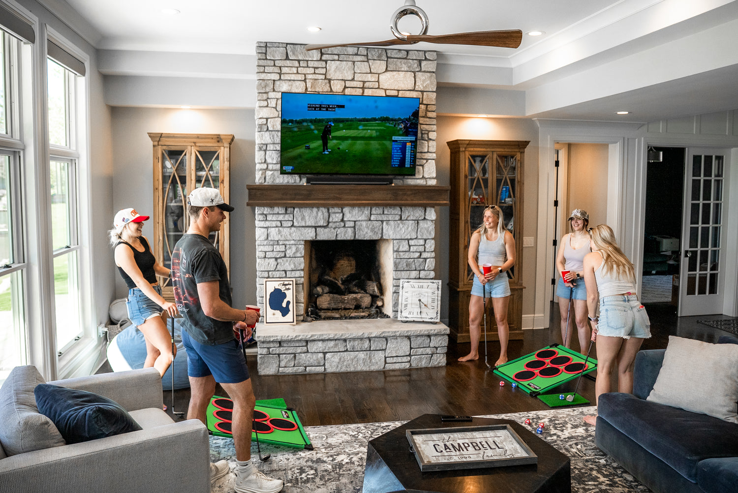 Friends playing Golf Pong in the living room.